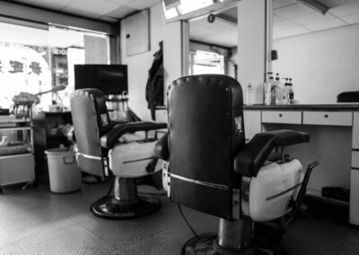 A vintage barbershop interior with classic barber chairs and mirrors in black and white.