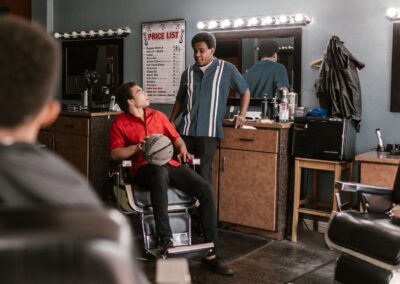 A bustling barbershop with customers engaged in conversation, surrounded by classic decor.